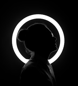 woman standing beside halo light