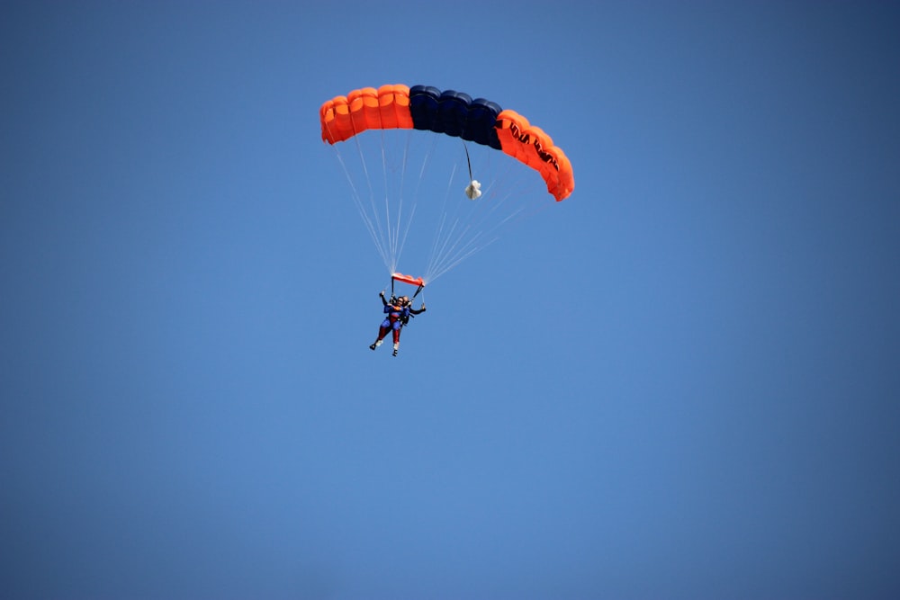 photography of person doing parachute during daytime