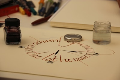 A clock and notebook symbolizing speedy lyric writing service.