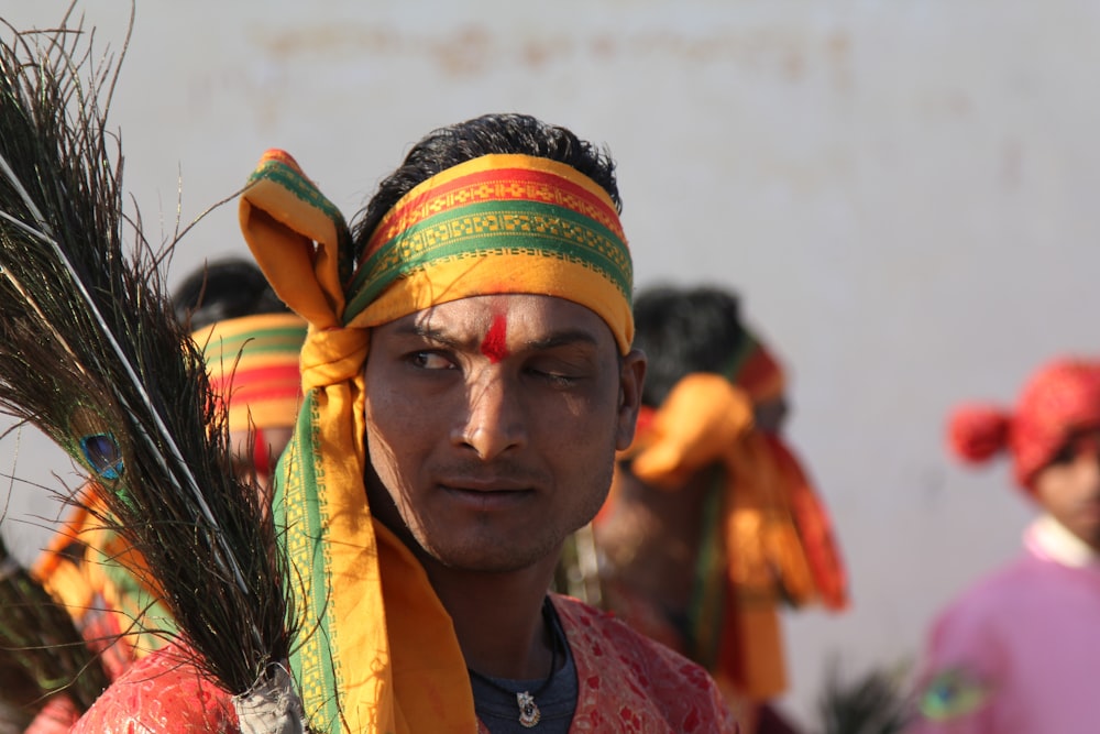 shallow focus photo of man wearing yellow and green headband