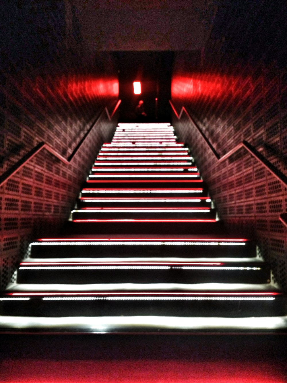 low-angle photography of a lighted narrow staircase