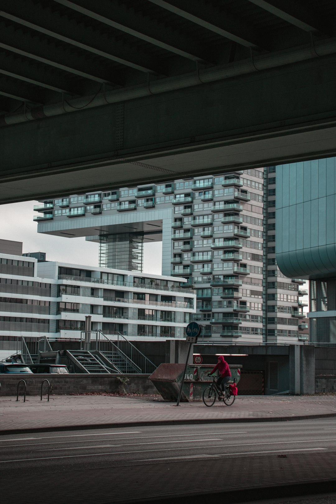 person riding bike on sidewalk during daytime