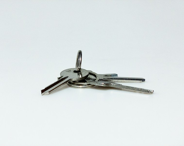 Three silver keys side by side, representing overlapping credential versions during a rotation