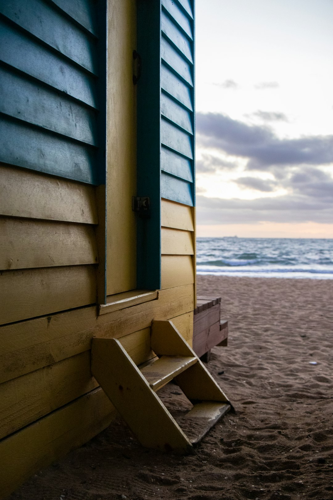 brown and blue wooden cottage by the beach