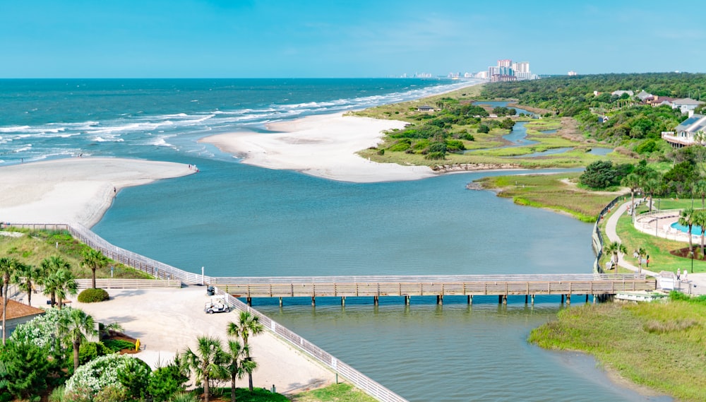 an aerial view of a beach and a bridge