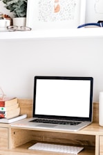 Minimalistic workspace featuring notebook, glasses, and forest green accents.
