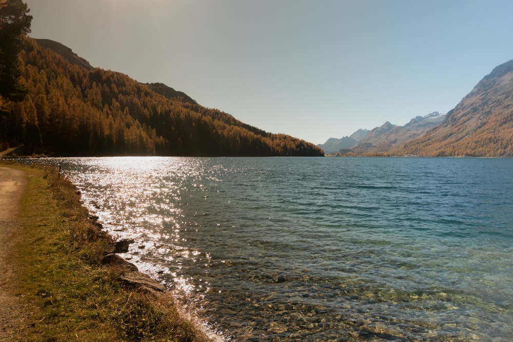 body of water and mountains during day