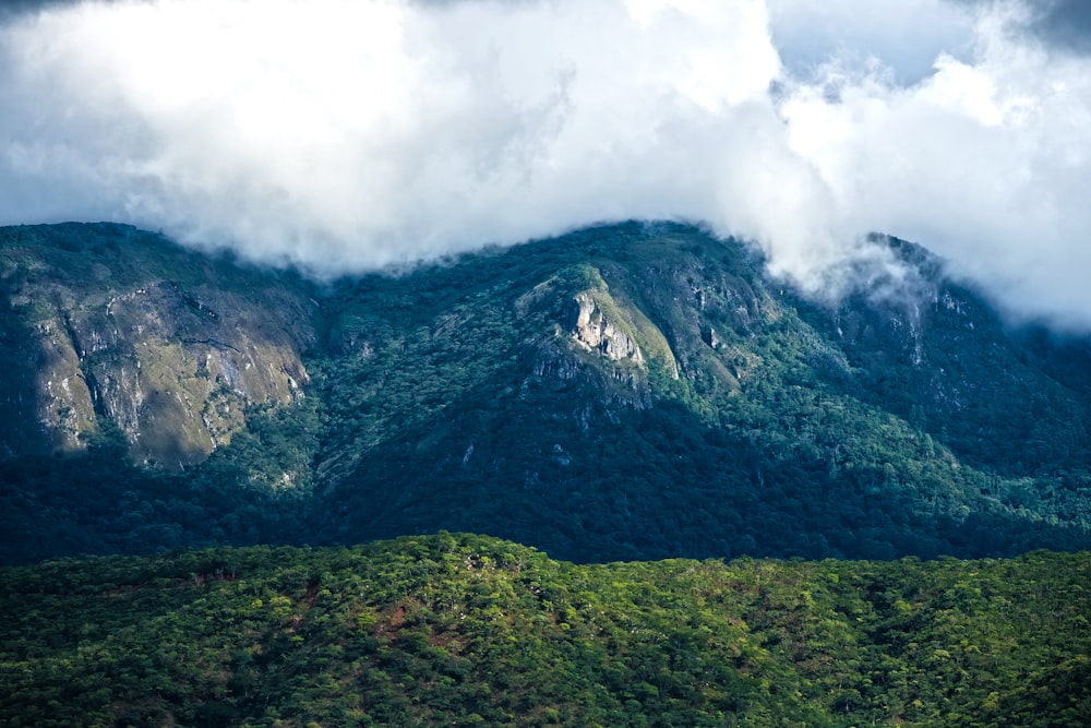 green mountains under cloudy sky