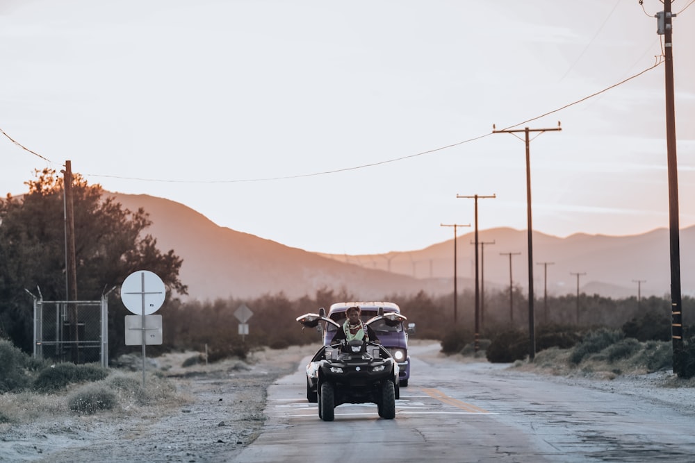 person riding ATV on road