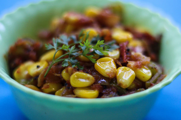 cooked corn kennel in bowl with herb