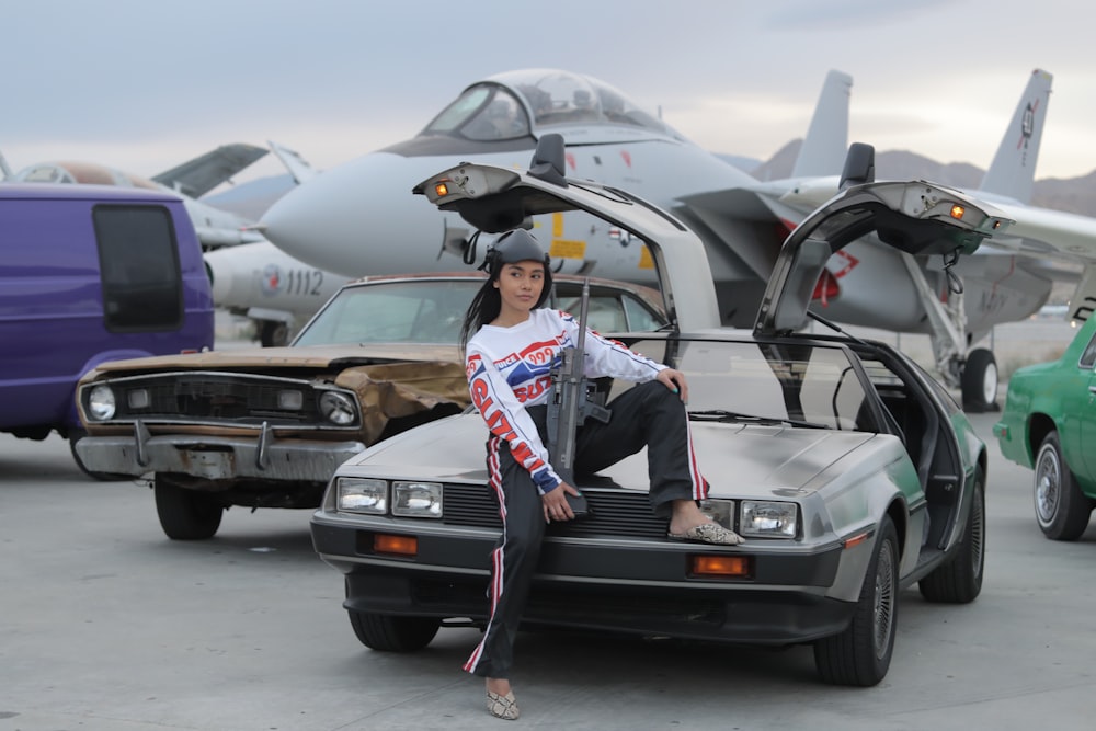 woman sitting on the gray vehicle