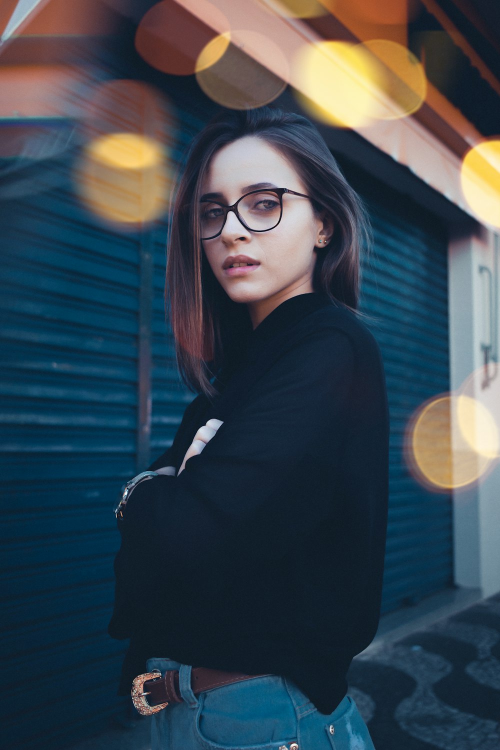 woman in black long-sleeved blouse wearing eyeglasses