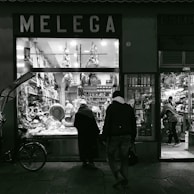 The storefront of a luxury butcher shop at dusk, glowing warmly inviting customers inside.