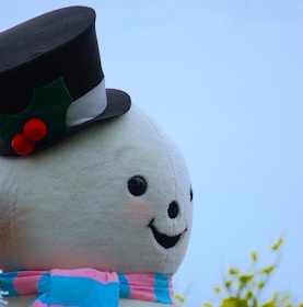 A cheerful printable Christmas card with a smiling snowman wearing a red scarf and top hat.