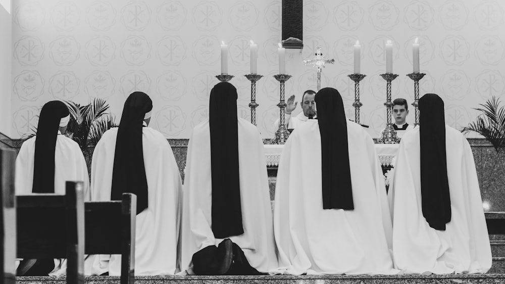 five person in white dresses