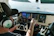 Technician inspecting the cockpit instruments of a small private aircraft.