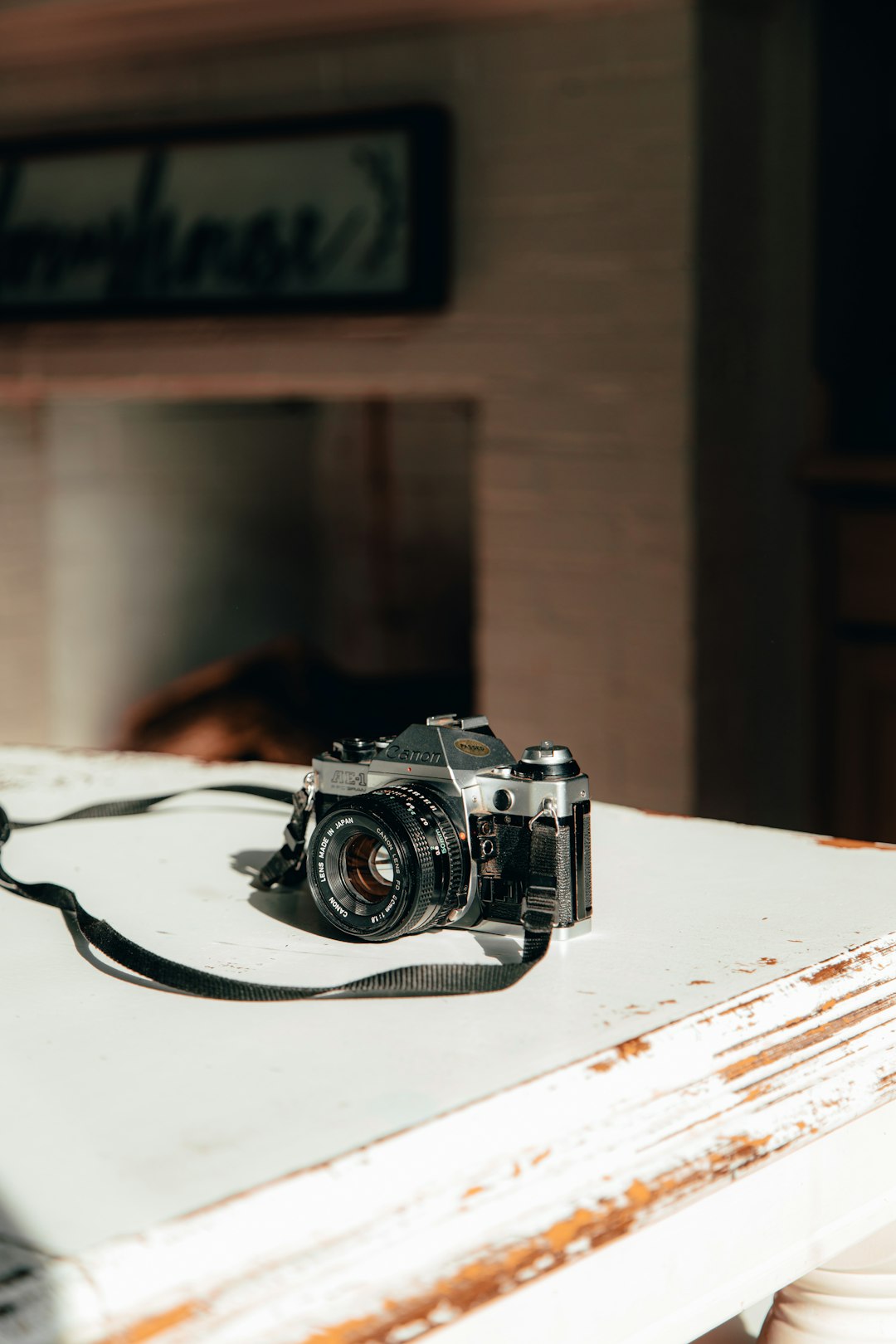 shallow focus photo of black SLR camera on white wooden table