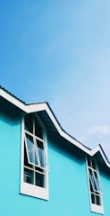 A vibrant blue roof contrasting beautifully with white walls on a sunny day.