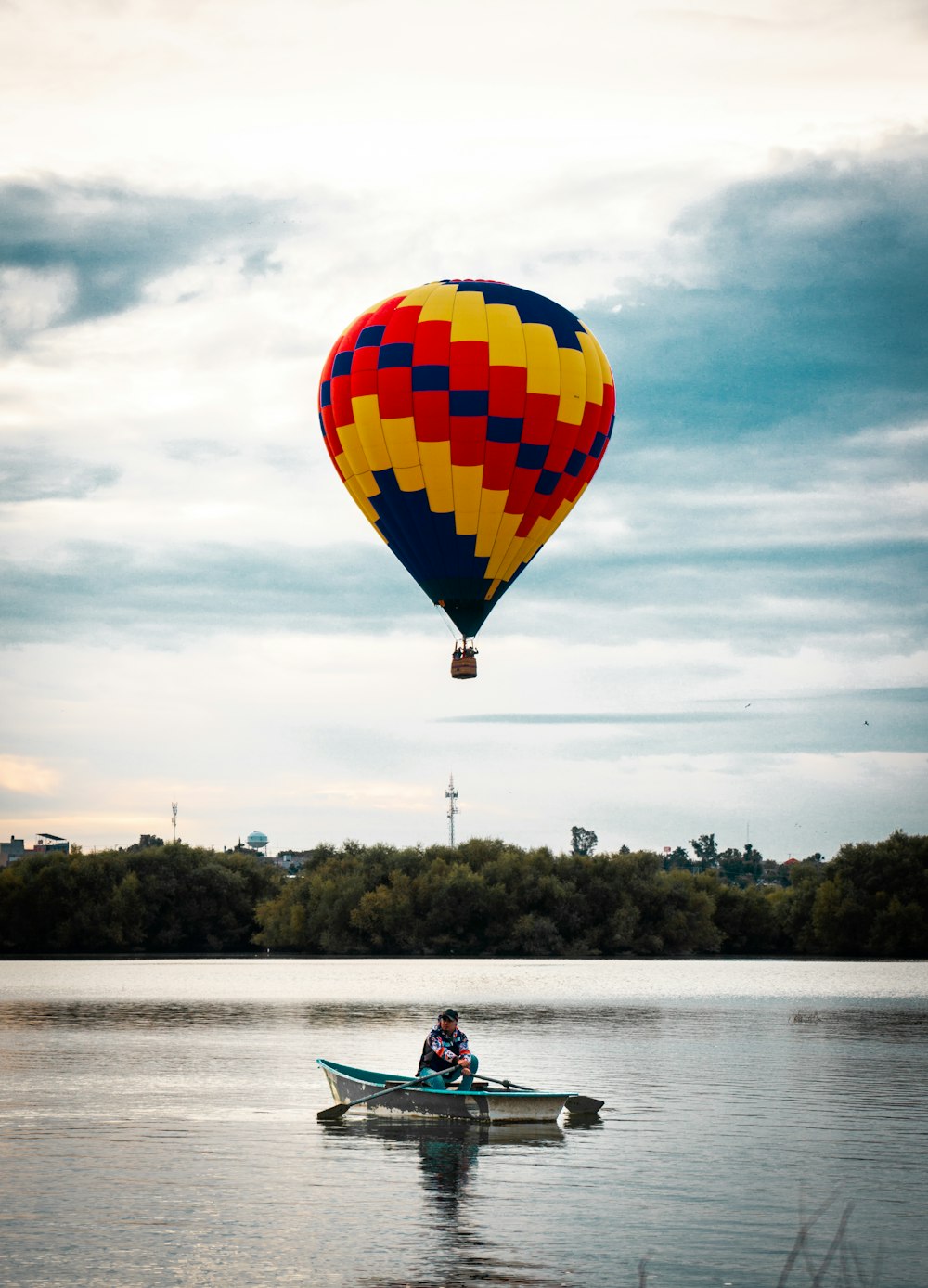 person riding boat on calm body of water