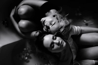 grayscale photography of two women sitting