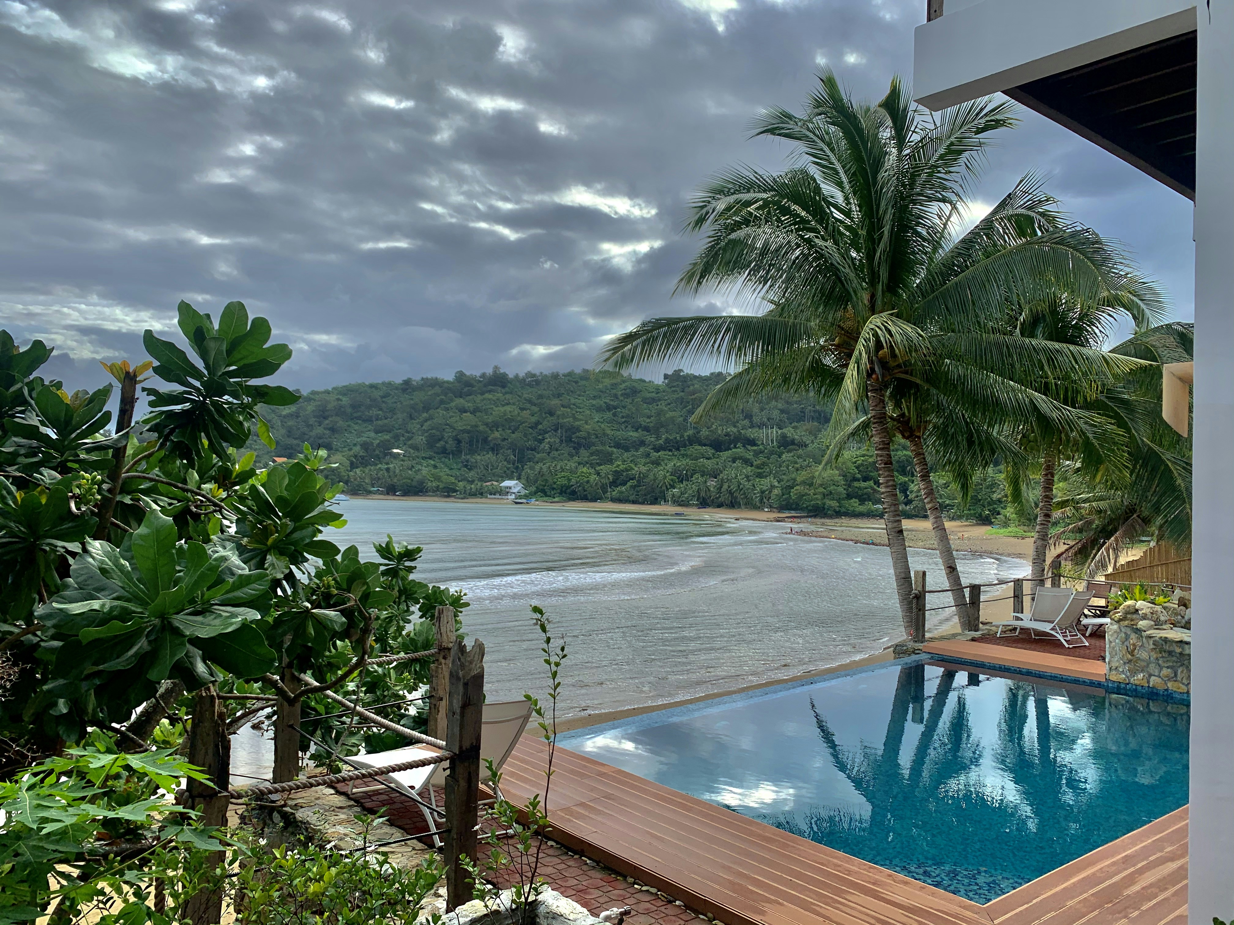 a view of a pool and a beach from a house