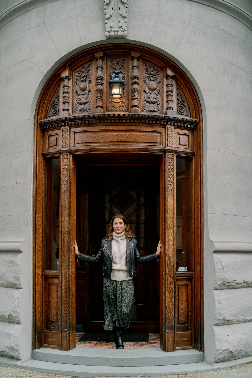 woman standing between doorway