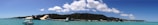 A panoramic view of the Dominican coastline with boats sailing near whales.