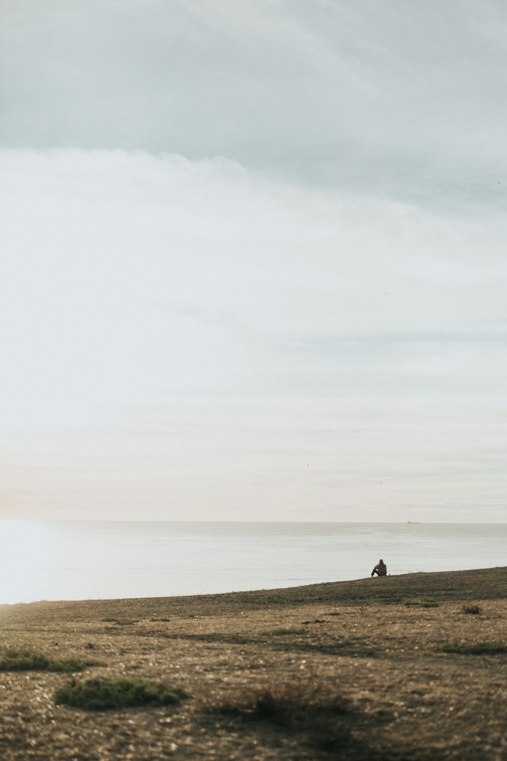 man sitting on shore