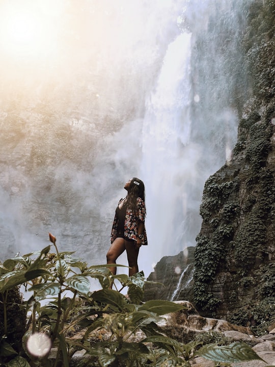 woman looking up at waterfalls in Lake Sebu Philippines