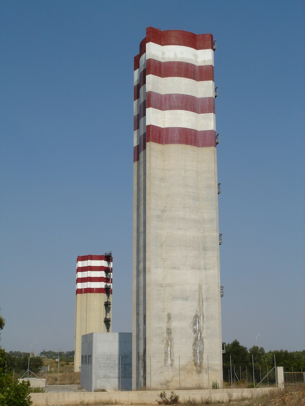 view photography of gray and red concrete tower building