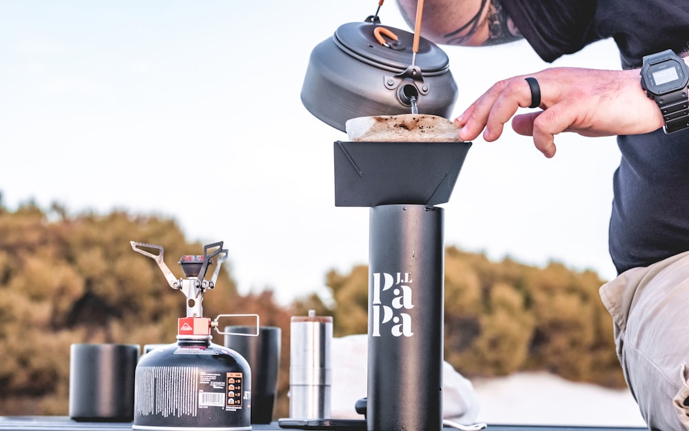 person pouring water on the bowl