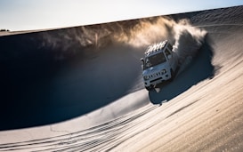 white SUV on desert during daytime