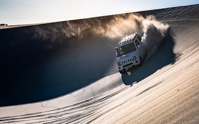white SUV on desert during daytime