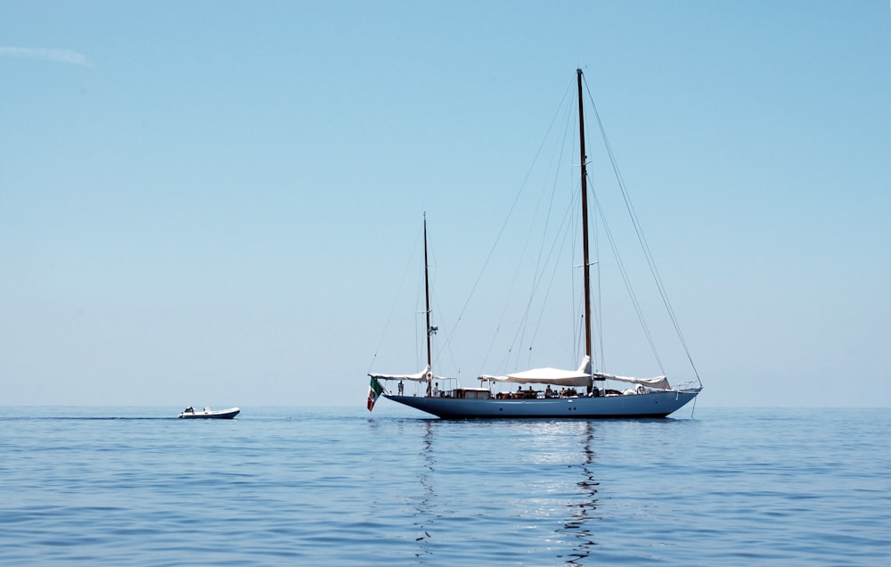 white sail boat on sea