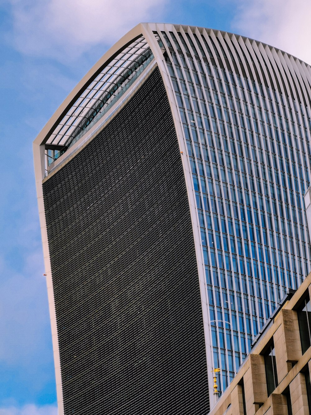 a very tall building with a sky background