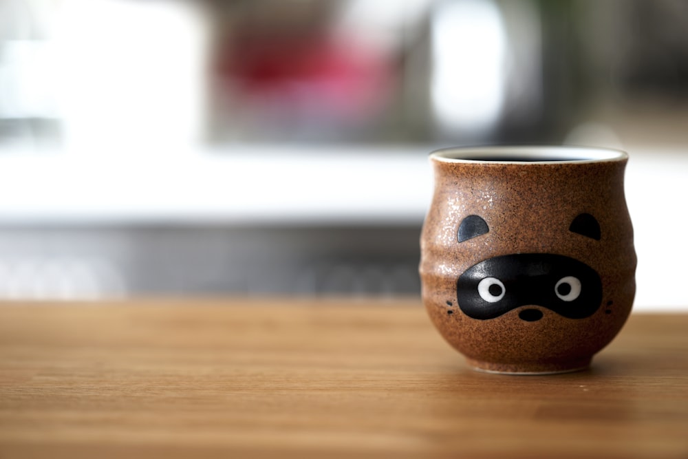 brown ceramic cup on table