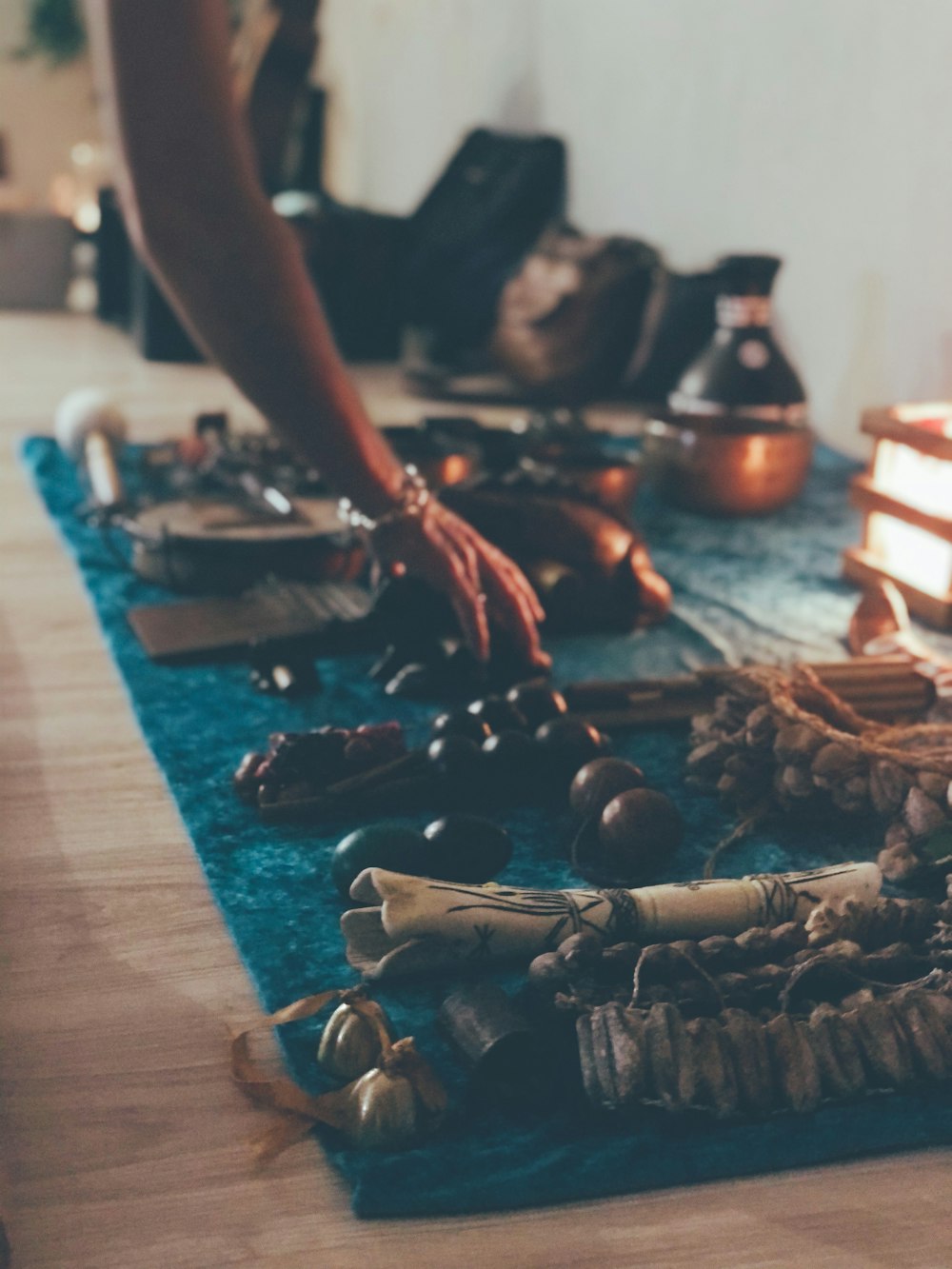 a person reaching for a necklace on a table