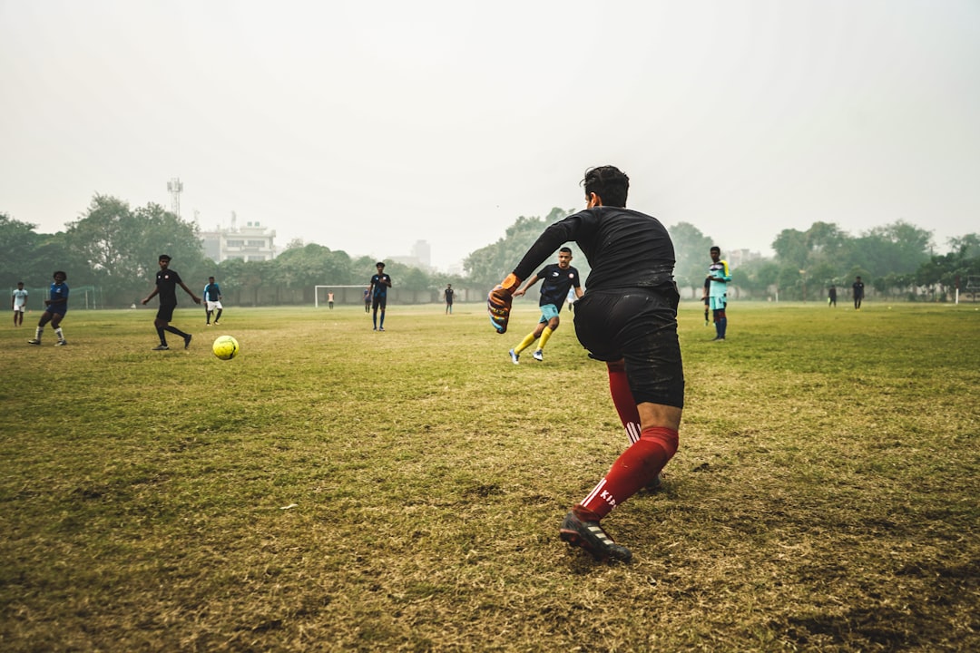 people playing soccer during daytime