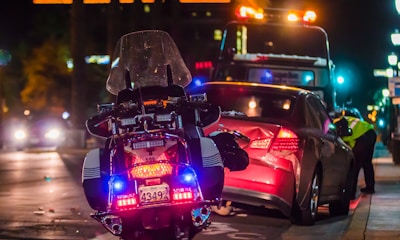 policeman leaning on sports car's window