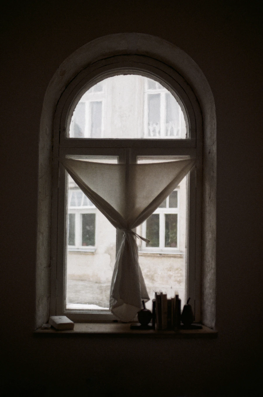 Curtain covering an arched window