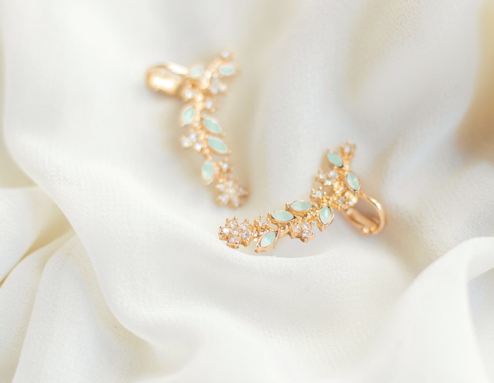 gold-colored earrings