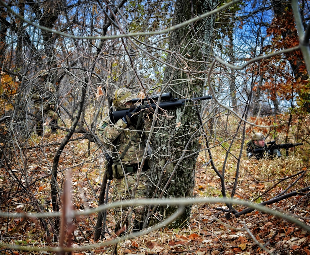 man aiming rifle