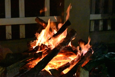 Warm fireplace glowing with flames fueled by firewood pallets.