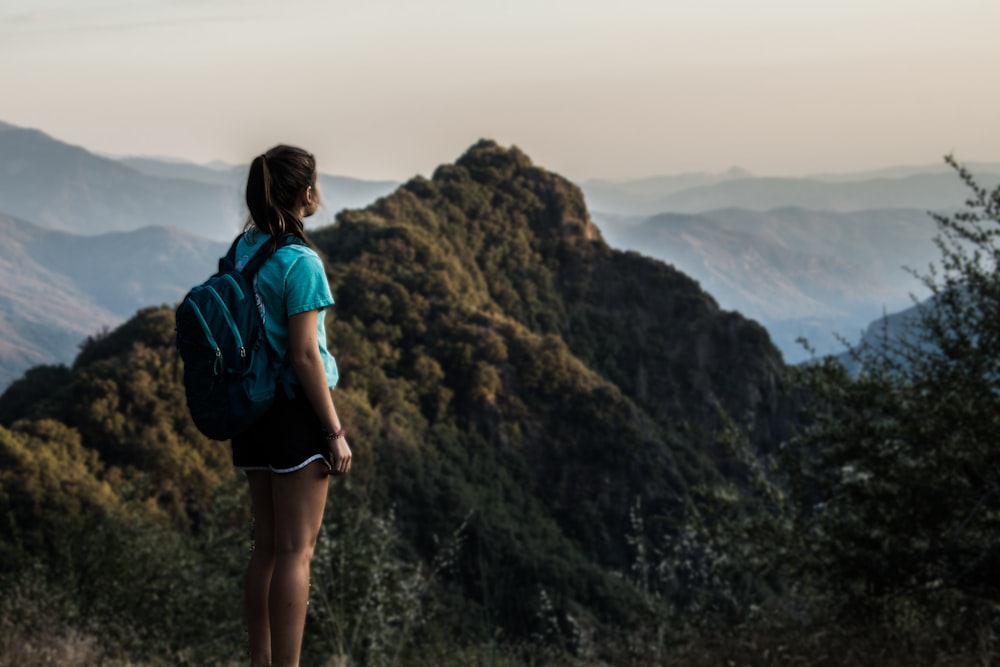 woman on hill in forest