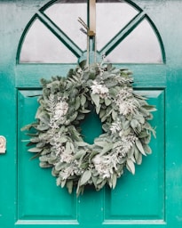 green leafy wreath hanging on door