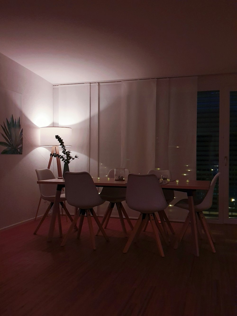 rectangular dining table with chairs beside window
