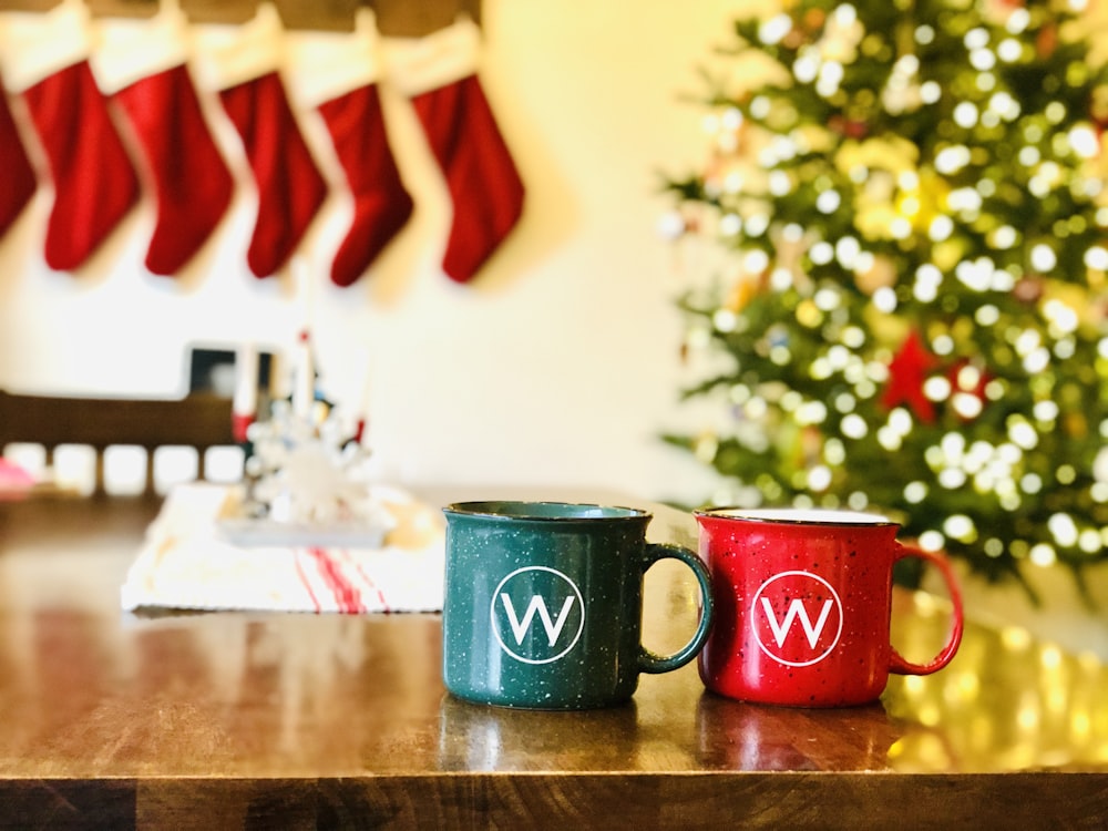 two red and blue mugs on a wooden table