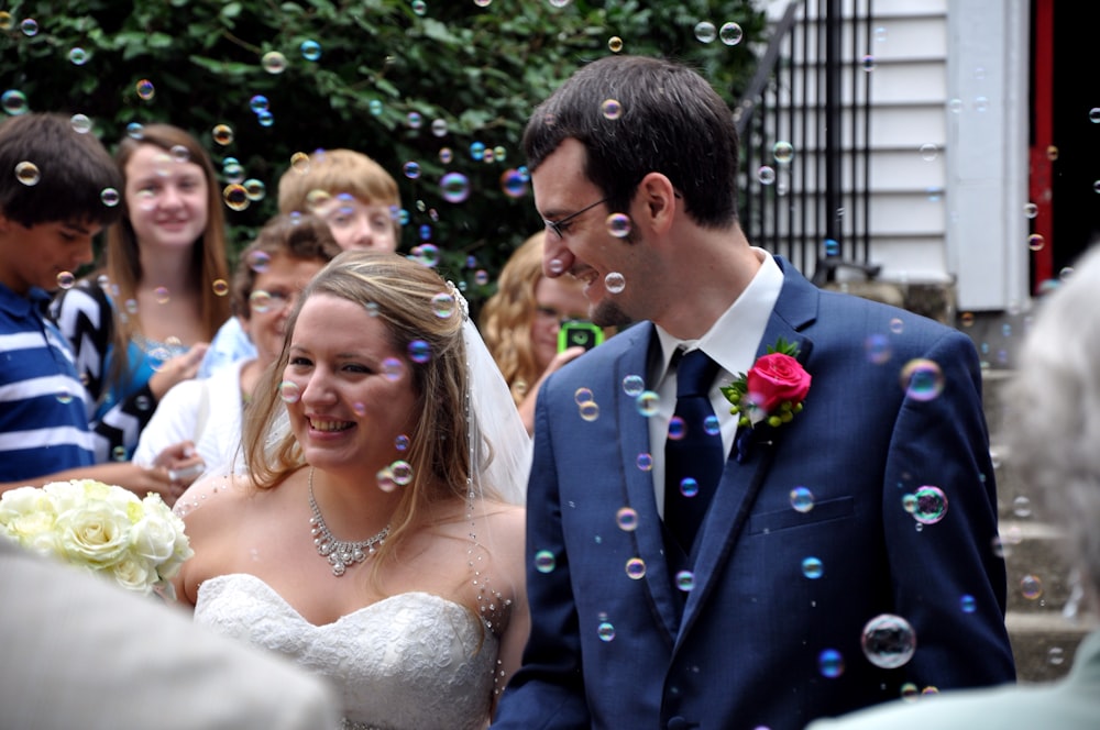 wedding couple walking between people