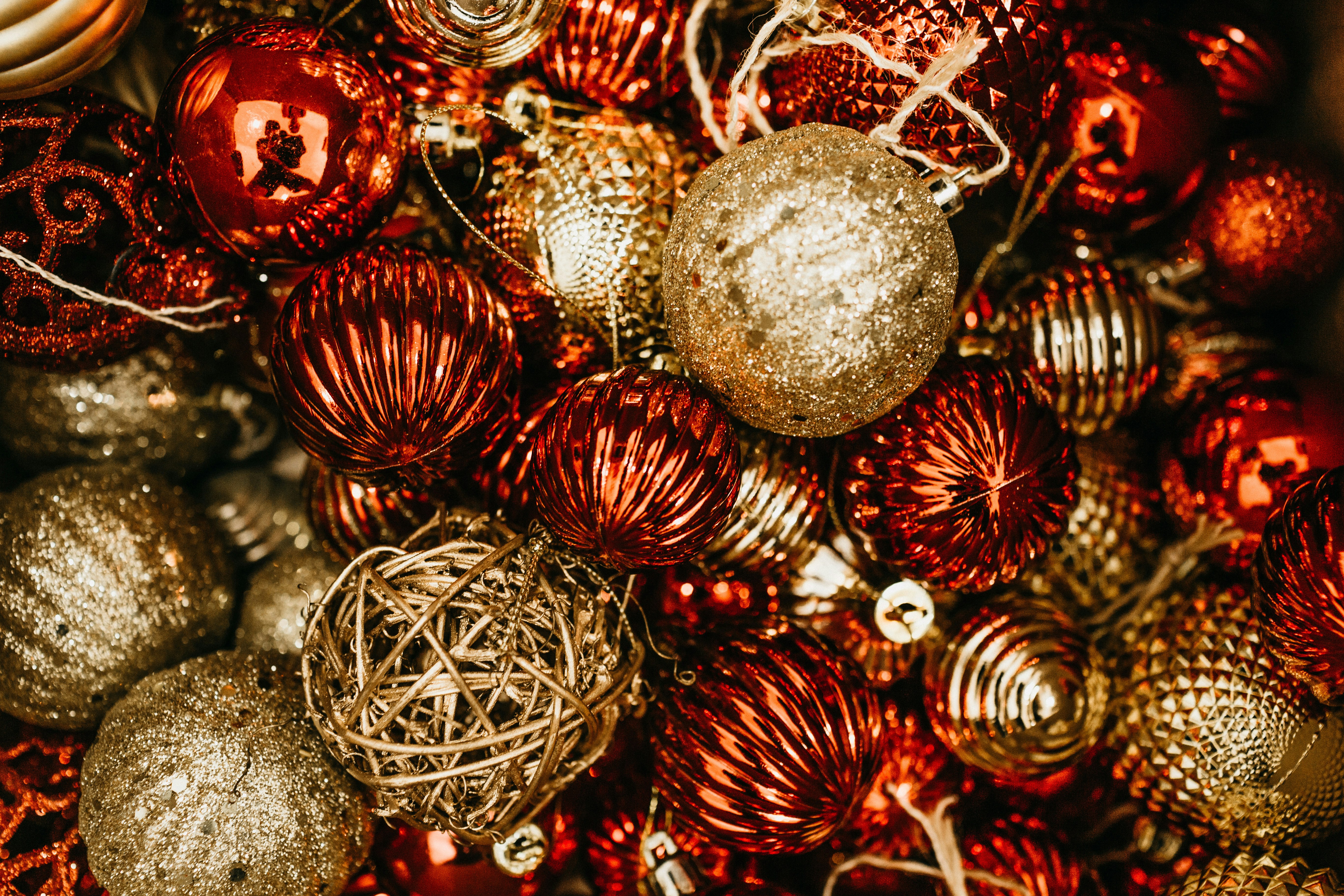 shallow focus photo of gold and red Christmas baubles