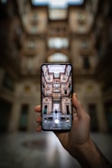 shallow focus photography unknown person holding black smartphone
